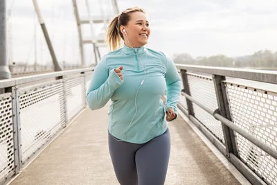 Abbildung einer joggenden Frau in sportlicher Kleidung.